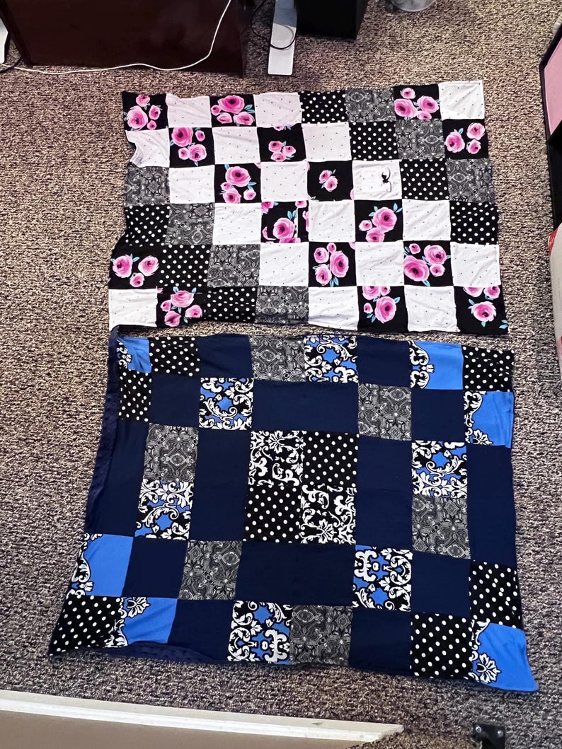 May include: Two patchwork quilts. The top quilt features squares of white with pink roses, black with white polka dots, and black squares. The bottom quilt has squares of navy blue, black with white polka dots, and black and white floral patterns.