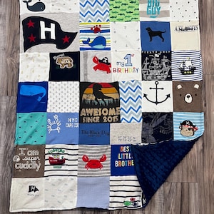 May include: A patchwork quilt made from various fabric squares, featuring nautical and animal-themed designs. The quilt includes images of whales, anchors, crabs, and the text "Awesome Since 2015". The quilt has a navy blue, textured backing.