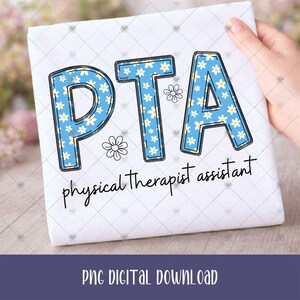 May include: A white t-shirt featuring the blue letters PTA filled with a white daisy pattern. Below the letters, the text physical therapist assistant is printed in black script. Two small white daisy outlines are placed near the letters.
