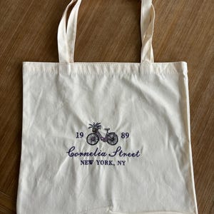 Bolsa de lona bordada con diseño de bicicleta, reutilizable.