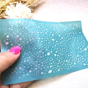 May include: A light blue stencil with a white polka dot pattern. The stencil is made of a thin, flexible material and is perfect for creating a variety of craft projects.