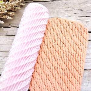 May include: Two rolling pins for baking, one pink with a wavy pattern and one orange with a rope pattern.