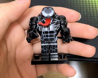 Superhero kills Venom minifigure and gives him her holiday gift