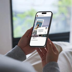 Woman on Phone with Mock. Modern travel creator viewing Mediterranean-inspired Instagram templates on phone – soft blues, sand tones, and breezy visuals.