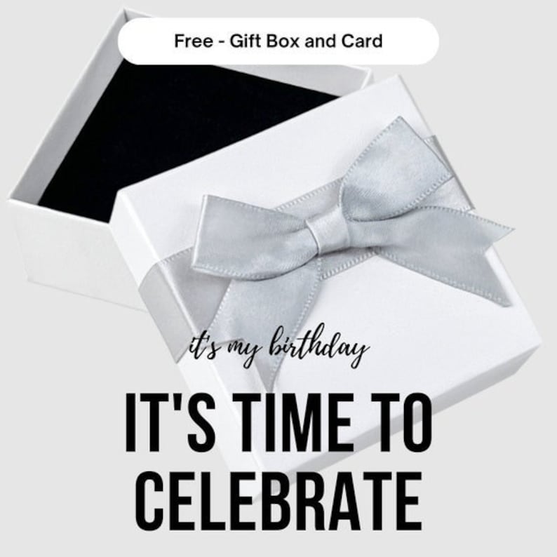 May include: White gift box with a silver ribbon and bow. The box is open and the inside is black. The text on the box says "it's my birthday IT'S TIME TO CELEBRATE".