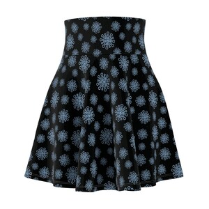 May include: A high-waisted skater skirt in black featuring an all-over repeating pattern of light blue, spiky, circular virus-like shapes. The skirt has a flared silhouette with a wide waistband and a consistent print across the entire garment.