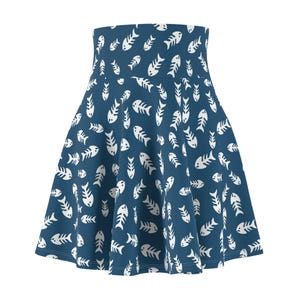 May include: A high-waisted skater skirt in a deep blue color featuring an all-over repeating pattern of white fish skeleton graphics. The skirt has a flared silhouette with a wide waistband and a smooth, consistent fabric texture throughout.