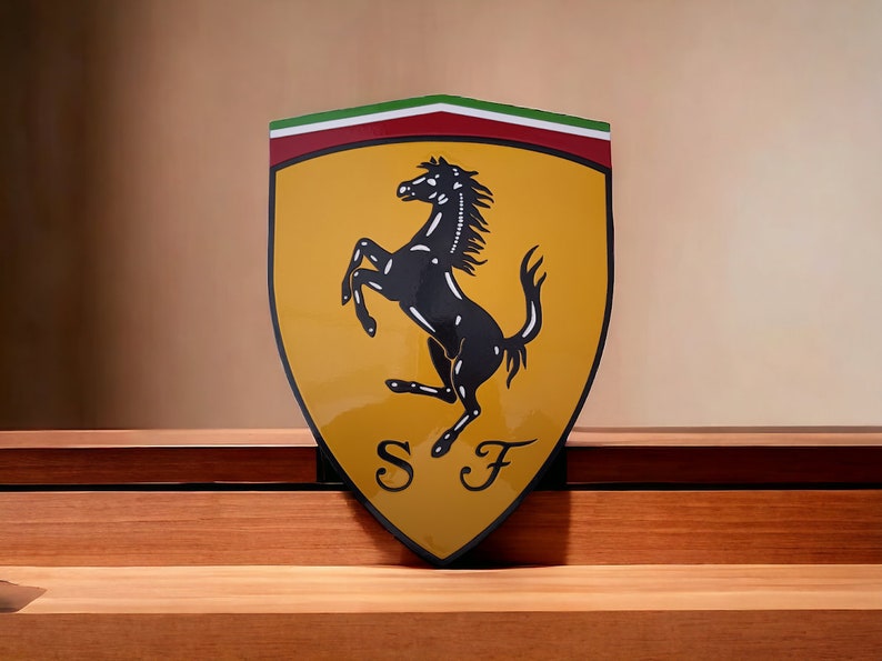 May include: A yellow shield with a black rearing horse and the letters "SF" in the center. The shield has a red and green stripe at the top.