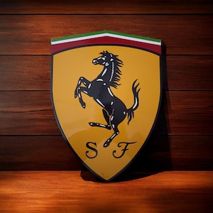 May include: A yellow and red shield with a black rearing horse and the letters "S F" in the center. The shield is a classic logo for the Italian car manufacturer Ferrari.