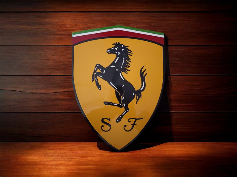 May include: A yellow and red shield with a black rearing horse and the letters "S F" in the center. The shield is a classic logo for the Italian car manufacturer Ferrari.