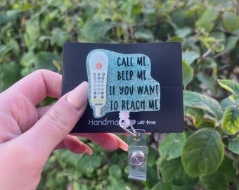 May include: A teal blue glitter badge reel with a white medical device and the text "Call me. Beep me. If you want to reach me. Handmade with love."