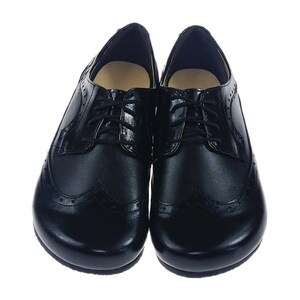 May include: A pair of black leather lace-up shoes with a wingtip design. The shoes have a rounded toe and a low heel.