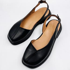 Mary Janes: bailarinas negras de piel con punta redonda y tacón abierto para mujer.