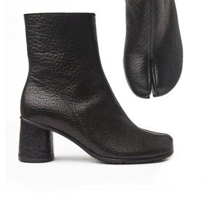 May include: Black leather ankle boots with a split-toe design, featuring a textured surface and a block heel. The boots have a rounded toe and a heel height of approximately 6.35 cm.