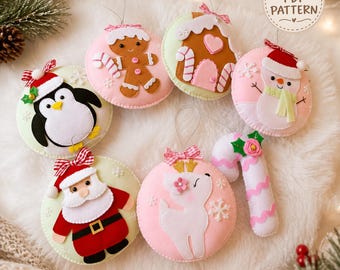 May include: A collection of seven felt Christmas ornaments featuring a gingerbread person, a gingerbread house, a snowman, a penguin, Santa Claus, a reindeer, and a candy cane. Each ornament has a hanging loop and the text PDF PATTERN is visible.