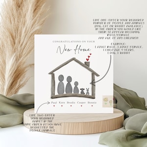 May include: A personalized new home card with a hand-drawn illustration of a house made of driftwood. The house has a chimney and a family of four people and two pets inside. The card is decorated with red hearts and the text "Congratulations on your New Home".