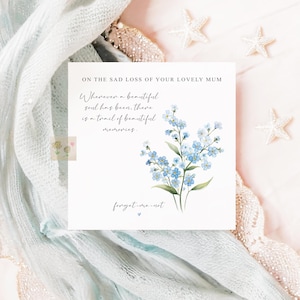 May include: A square sympathy card featuring the text "ON THE SAD LOSS OF YOUR LOVELY MUM" and a watercolor illustration of blue forget-me-nots. The card also includes the text "Whenever a beautiful soul has been, there is a trail of beautiful memories."