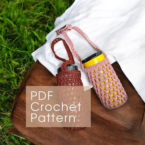 May include: Two crochet water bottle holders, one brown and one pink, with straps. The holders are made with an open weave pattern. The image also includes the text "PDF Crochet Pattern". The holders are on a wooden surface.