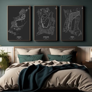May include: Three black and white framed prints of race track maps. The maps are of the Monaco, Interlagos, and Monza race tracks. The prints are hanging on a dark green wall above a bed with a beige duvet and green throw blanket.