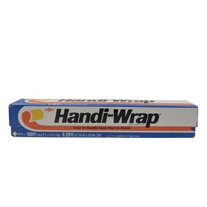 May include: A rectangular box of Handi-Wrap plastic film with blue, white, and orange branding. The packaging displays the text Handi-Wrap, Easy to Handle from Start to Finish, and dimensions of 100 SQ FT (103 FT x 11 3/4 IN) and 9.29 SQ M.