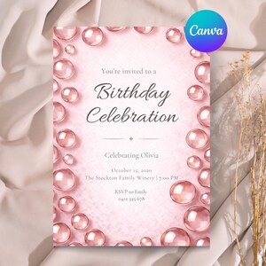 Op de afbeelding: Een roze verjaardagsuitnodiging met een aquarelontwerp. De uitnodiging bevat de tekst "You're invited to a Birthday Celebration" en details van het evenement. Decoratieve roze bollen omringen de tekst. Het Canva-logo staat rechtsboven.