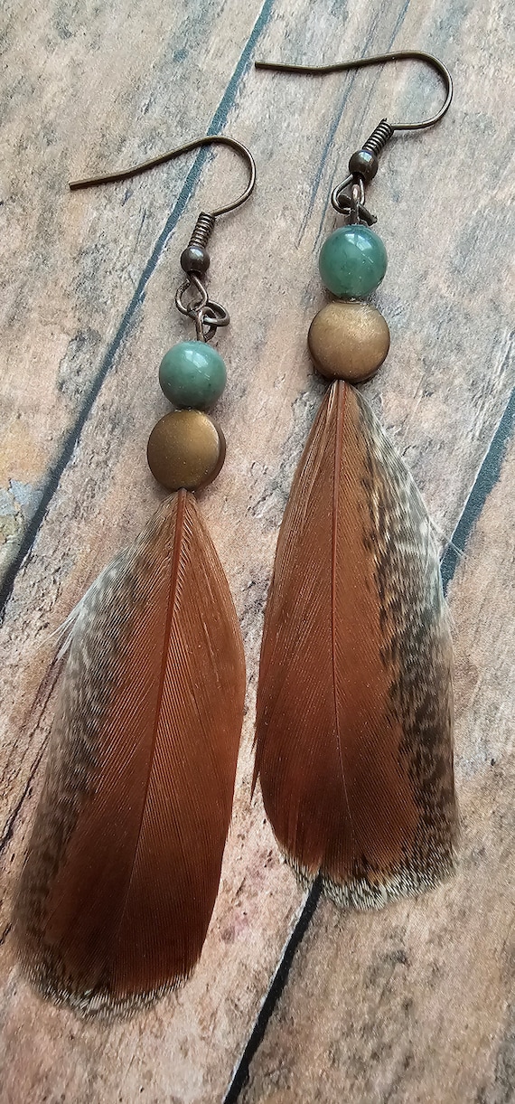 Brown feather earrings with aqua colored beads and metal detail