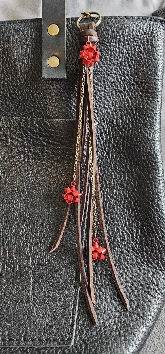 Holiday brown leather keychain/bag charm with brass chain detail and red metal bows