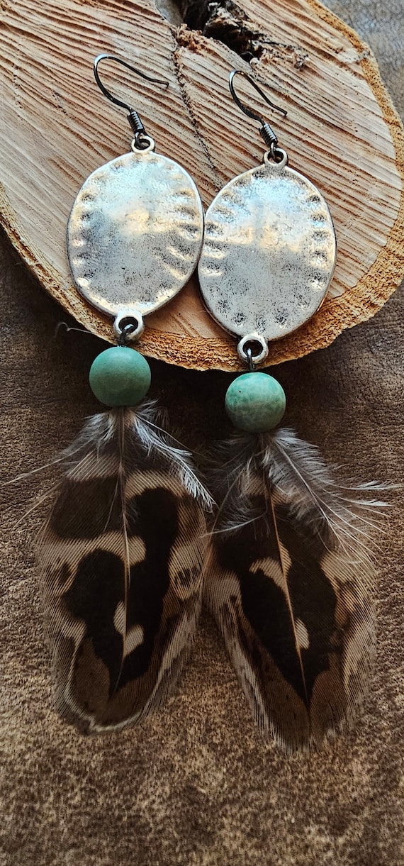 Hammered metal and natural bird feather earrings with turquoise beads