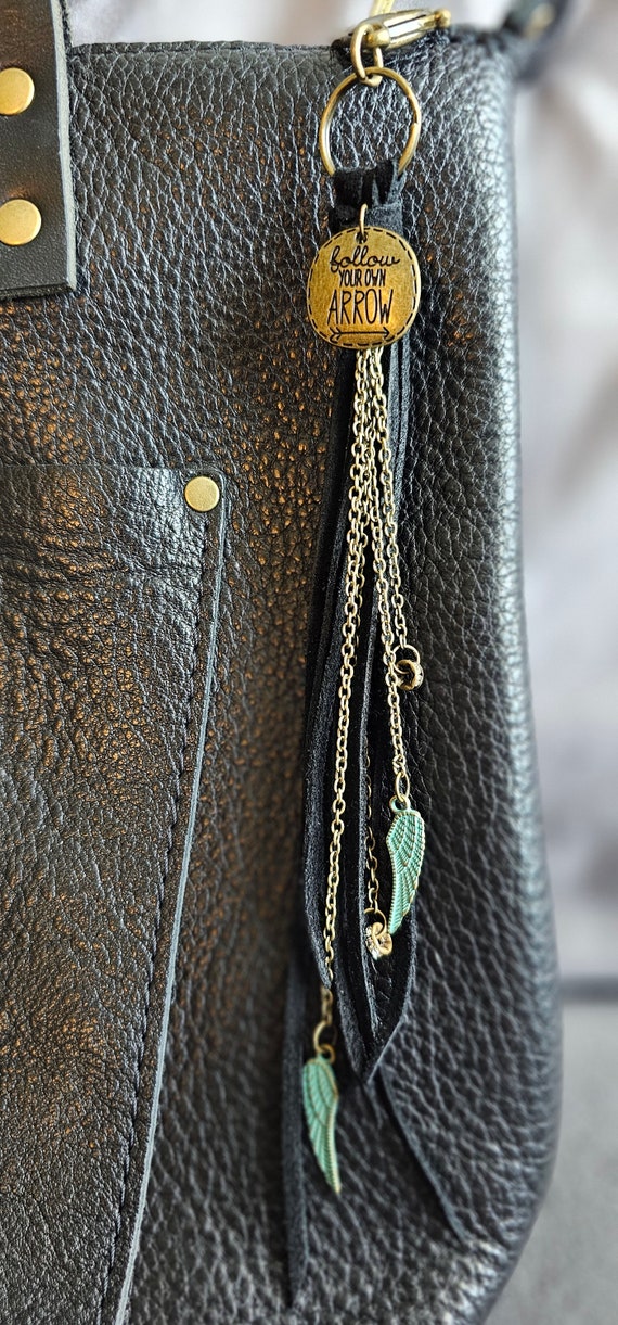Suede *Follow Your Own Arrow* Keychain with brass chain detail and turquoise wing charms