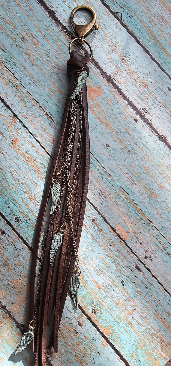 Brown leather keychain/ bag charm with brass details and turquoise wing charms