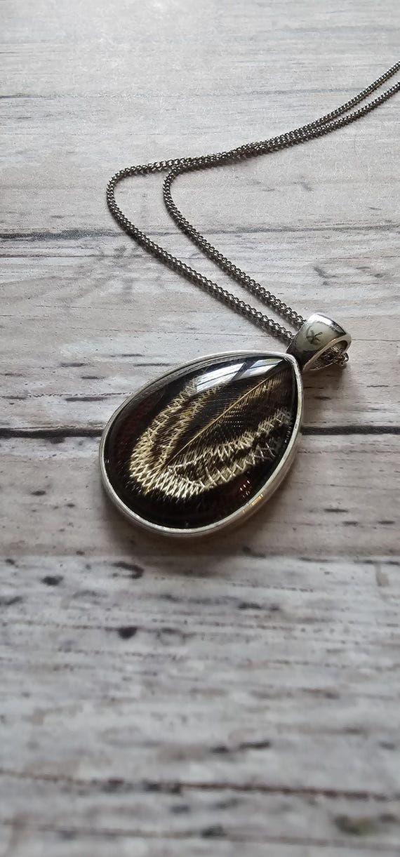 Natural pheasant feather resin sealed in a glass cabochon pendant necklace