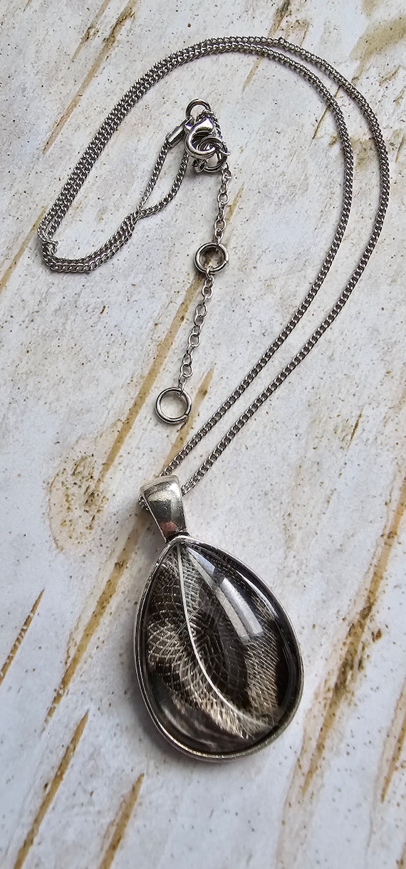 Natural bird feather resin sealed in a glass cabochon pendant necklace