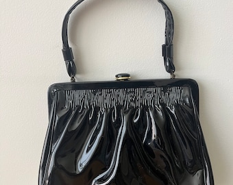 Patent Leather Handbag with handle on top from the 1960s.  Gold and Black Button Closure Vintage MCM hard to find great condition purse