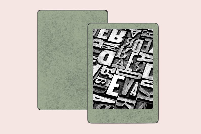 May include: A green e-reader with a black and white image of a jumbled collection of letters on the screen.