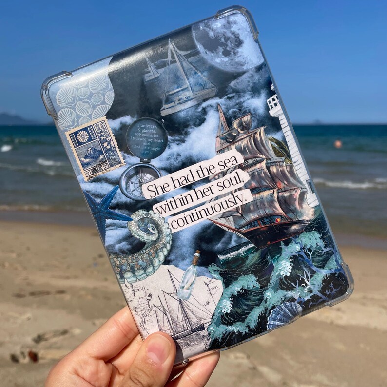 May include: Clear tablet case with a nautical theme. The case displays a collage of ocean elements, including a sailboat, octopus, compass, and the text "She had the sea within her soul, continuously." The background features a stormy sea and moon.