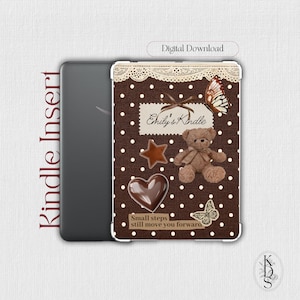 May include: A digital download Kindle insert featuring a brown background with white polka dots, a lace border, a teddy bear, a heart, a star, butterflies, and the text Emily's Kindle and Small steps still move you forward.