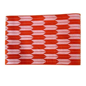 May include: A rectangular fabric piece featuring a repeating arrow pattern in vibrant orange and soft pink. The design consists of horizontal rows of stylized, pointed arrow shapes that alternate in color, creating a consistent geometric texture.