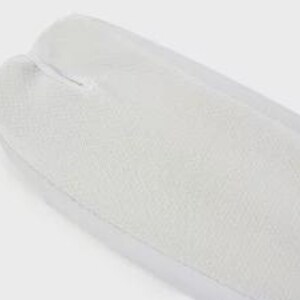 May include: White tabi socks with a split toe design. The socks are made of a soft, breathable fabric.
