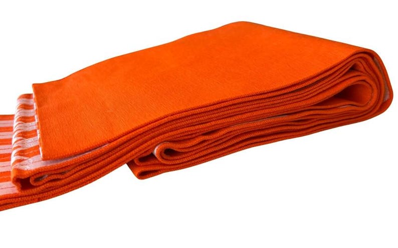 May include: A folded rectangular textile piece featuring a solid vibrant orange color on one side and a pattern of alternating orange and white horizontal stripes on the reverse side, showing a textured knit construction throughout the fabric.