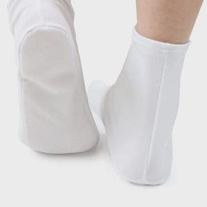 May include: A pair of white ankle-length socks with a smooth, textured surface. The socks are made of a soft, breathable material.