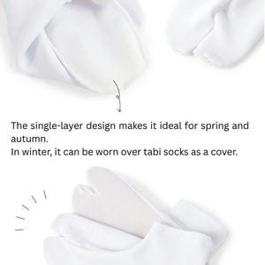 May include: White tabi socks with a split toe design. The socks are made of a single layer of fabric and can be worn over other socks for warmth.