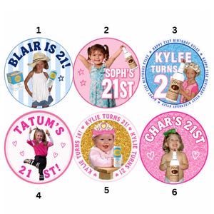May include: Six circular stickers featuring birthday themes. Sticker 1: BLAIR IS 21! with a child in a hat. Sticker 2: SOPH'S 21ST with a child holding a bottle. Sticker 3: KYLEE TURNS 21 with a child. Sticker 4: TATUM'S 21ST with a child. Sticker 5: KYLIE TURNS 21! with a baby. Sticker 6: CHAR'S 21ST with a child holding a bottle.