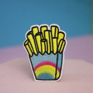May include: An embroidered patch featuring a container of chips with a rainbow design on the container.