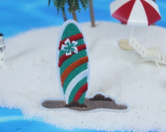 May include: Green and red striped surfboard with a white flower design, embroidered patch.