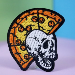 May include: An embroidered iron-on patch featuring a white skull with a pizza slice for a mohawk. The pizza slice is yellow with orange crust and pepperoni.