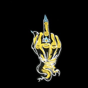 May include: A yellow embroidered patch of a hand giving the middle finger with an all-seeing eye in the palm.