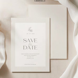 May include: A cream-colored Save the Date card featuring a vertical pinstripe border and dark gray serif typography. The text reads Oakley&Co., EM, 06-19-2026, SAVE the DATE, Emilia Bakton and Matt Richards are getting married in Westerly, RI on June 19, 2026.