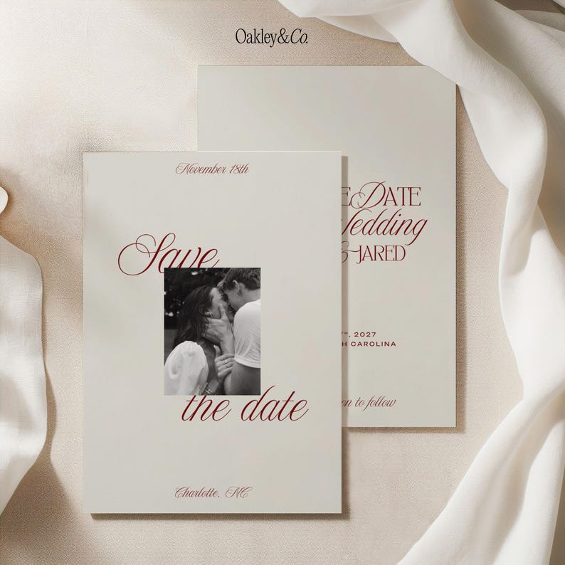 May include: Two rectangular cream-colored save the date cards with dark red serif and script typography. The front card features a black and white photograph of a couple, the text "Save the date", "November 18th", and "Charlotte, NC". The brand "Oakley&Co." is at the top.