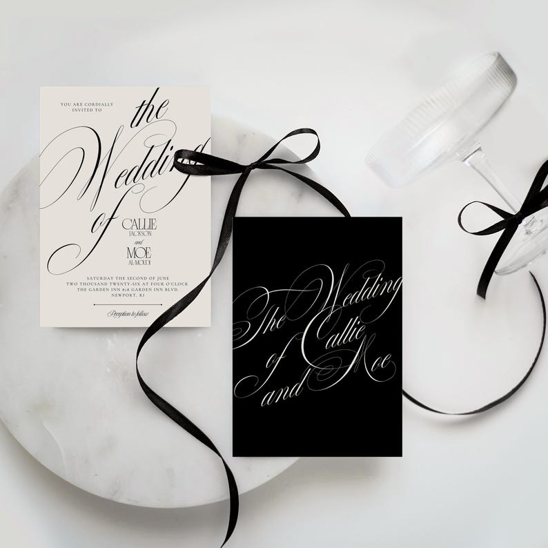 K&ouml;nnte beinhalten: Eine cremefarbene Hochzeitseinladungskarte mit schwarzem Text und eine passende schwarze Karte mit wei&szlig;er Kalligrafie, beide mit einem d&uuml;nnen schwarzen Band zusammengebunden. Die Einladung nennt die Hochzeit von Callie Jackson und Moe Alakely.