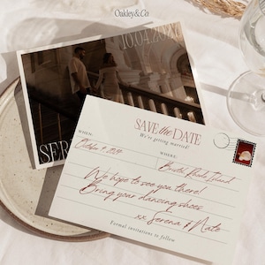 May include: A cream-colored postcard-style Save the Date card with dark red cursive text reading 'Save the Date', 'October 4, 2027', 'Bristol, Rhode Island', and 'Serena & Nate'. It features a photo of a couple on stairs and a small stamp graphic.